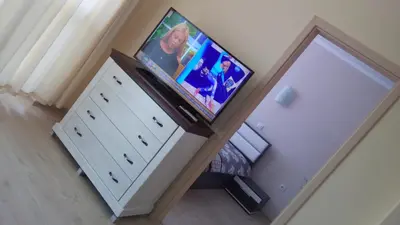 a television on top of a dresser in a room at Villa Roma Monna in Nesebar