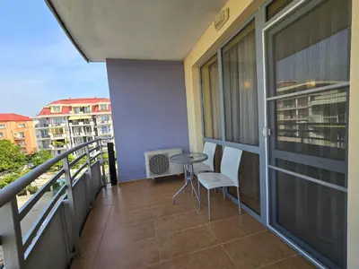 a balcony with a table and chairs on a building at Apartment in Central Plaza in Sunny Beach