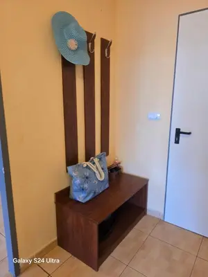 a hat and a purse sitting on a wooden bench at Apartment in Central Plaza in Sunny Beach