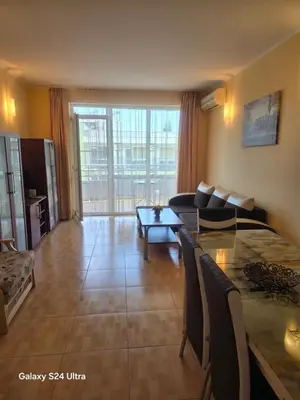 a living room with a couch and a table at Apartment in Central Plaza in Sunny Beach