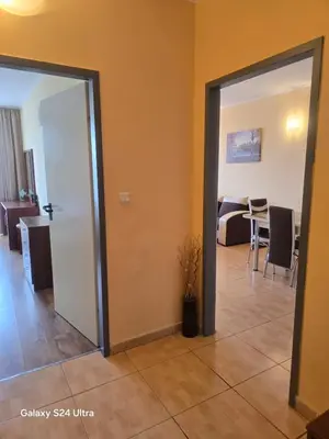 a room with an open door and a dining room at Apartment in Central Plaza in Sunny Beach