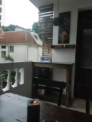 a view of a balcony with a table and a sink at Rali Apartments in Kiten