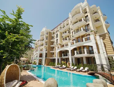 a hotel with a swimming pool in front of a building at Harmony Suites - Dream Island in Sunny Beach