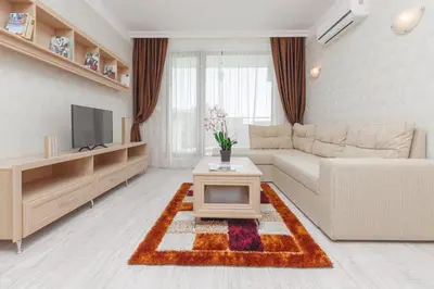 a living room with a couch and a tv at Harmony Suites - Dream Island in Sunny Beach