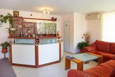 a living room with a couch and a table at Guesthouse Kirov in Ravda