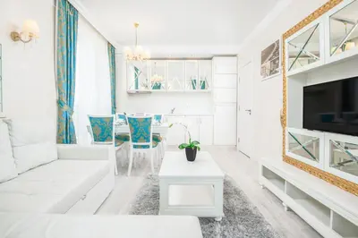 a white living room with a white couch and a table at Harmony Suites Saint Vlas in Sveti Vlas