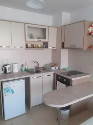 a kitchen with a sink and a counter top at Апартаменти и стаи Анхиало in Pomorie