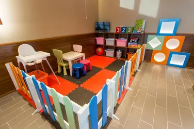 a toy room with chairs and a table at Hotel Provadia in Provadiya