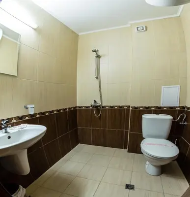 a bathroom with a toilet and a sink at Family hotel Apolon in Nesebar