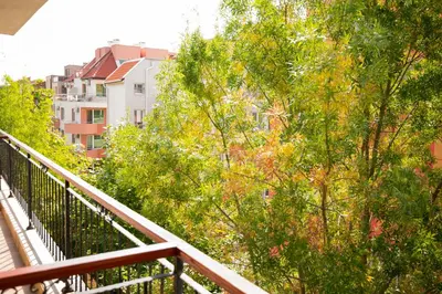 a balcony with a view of trees and buildings at Family hotel Apolon in Nesebar