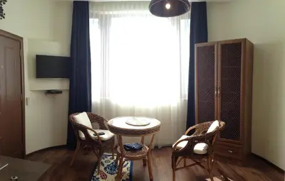 a room with a table and chairs and a window at Guest Rooms Maria Luiza in Varna City