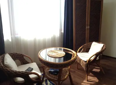 a living room with chairs and a table and a window at Guest Rooms Maria Luiza in Varna City