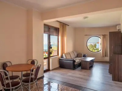 a living room with a couch and a table at Hotel Fantasy Beach in Sveti Vlas