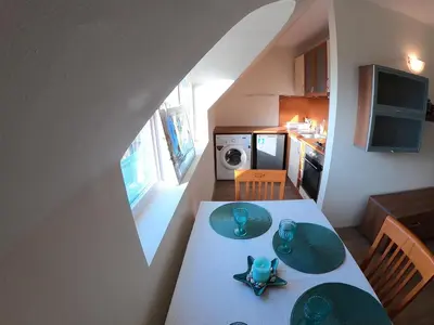 a small kitchen with a table with plates on it at Aquaria Holiday Apartments in Sunny Beach