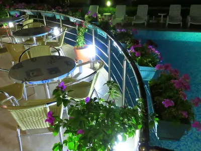 a group of tables and chairs with flowers on them at Aquaria Holiday Apartments in Sunny Beach