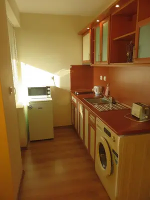 a small kitchen with a sink and a washer at Aquaria Holiday Apartments in Sunny Beach