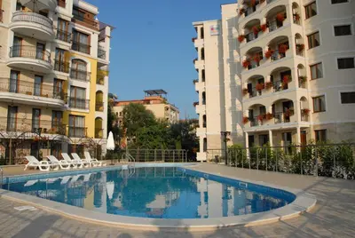 a swimming pool in front of two tall buildings at Hotel Seasons 3 in Sunny Beach
