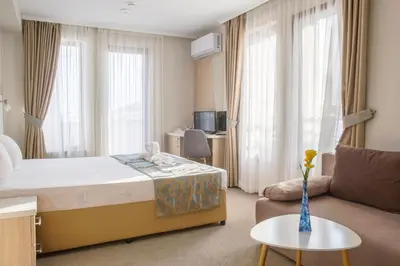 a hotel room with a bed and a couch at Melia Mar in Sozopol