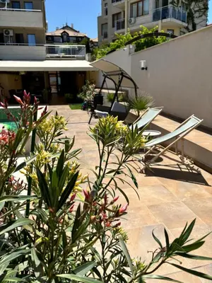 a patio with chairs and plants on a building at Melia Mar in Sozopol