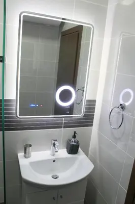 a bathroom with a white sink and a mirror at Super Central Luxury Apartments in Burgas City