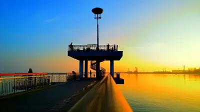 a pier with people on it in the water at Super Central Luxury Apartments in Burgas City