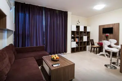 a living room with a couch and a table at Super Central Luxury Apartments in Burgas City