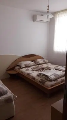 a bedroom with a bed in the corner of a room at Sea Bedroom Apartments in Nesebar