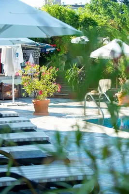 a group of tables and chairs with umbrellas and flowers at Siena Palace in Primorsko