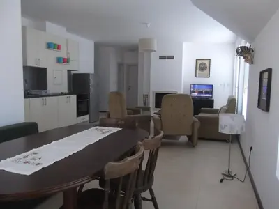 a kitchen and living room with a table and chairs at Apartment Sredna Gora in Burgas City