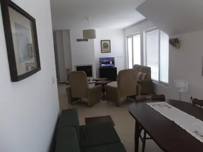 a living room with a couch and chairs and a table at Apartment Sredna Gora in Burgas City