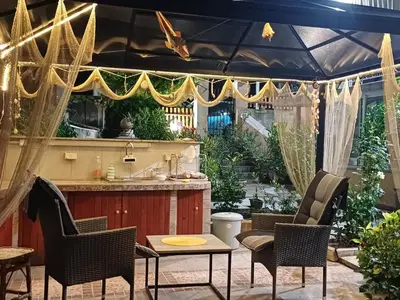 a patio with a bar with chairs and a table at Dom Zaharievi in Byala
