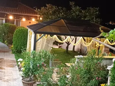 a gazebo in the yard of a house at night at Dom Zaharievi in Byala