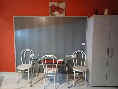 a table and four chairs in a room at Studio Nera in Pomorie