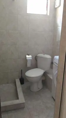 a bathroom with a toilet and a sink at Studio Nera in Pomorie