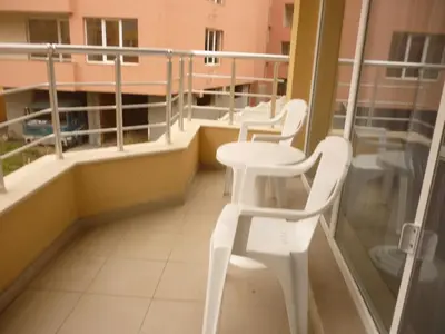 a balcony with two white chairs and a table at Studio Nera in Pomorie
