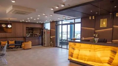 a lobby with a bar and a kitchen and a living room at Aparthotel Paradiso in Nesebar
