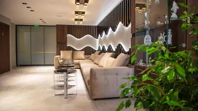 a living room with a couch and some plants at Aparthotel Paradiso in Nesebar