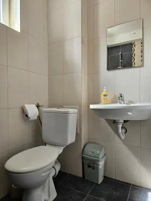 a bathroom with a toilet and a sink at Family House Manolov in Obzor