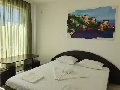 a bedroom with a bed with two towels on it at Family House Manolov in Obzor