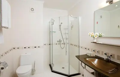 a bathroom with a shower and a sink and a toilet at Calypso Hotel - All Inclusive in Sunny Beach