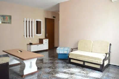 a living room with a chair and a table at Hotel Eos in Kiten