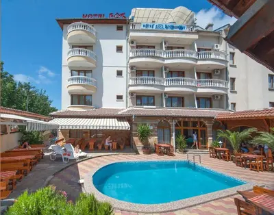 a hotel with a swimming pool in front of a building at Hotel Eos in Kiten