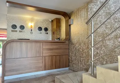 a room with a wooden cabinet and a wall at Family Hotel Kontesa in Lozenets