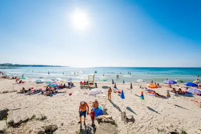 a group of people on a crowded beach at Riviera Fort Beach Apartments in Ravda