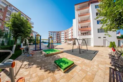 a playground in a courtyard in a building at Riviera Fort Beach Apartments in Ravda