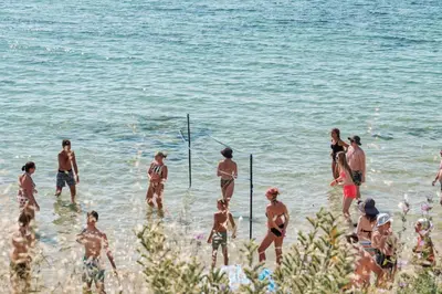 a group of people in the water at the beach at Riviera Fort Beach Apartments in Ravda