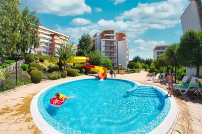 a group of people playing in a swimming pool at Imperial and Crown Fort Noks Grand Resort in Sveti Vlas