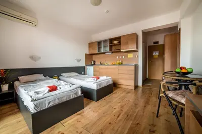 a large room with two beds and a kitchen at Step Hotel in Sunny Beach