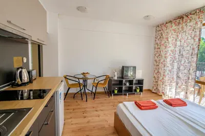 a kitchen with a bed and a table in a room at Step Hotel in Sunny Beach