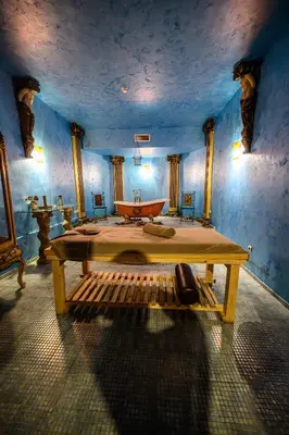 a bedroom with a large bed and a bath tub at Imperial Palace Hotel in Sunny Beach